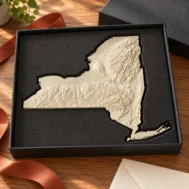 AI-generated concept of a New York State terrain relief in a dark gift box with fitted foam.