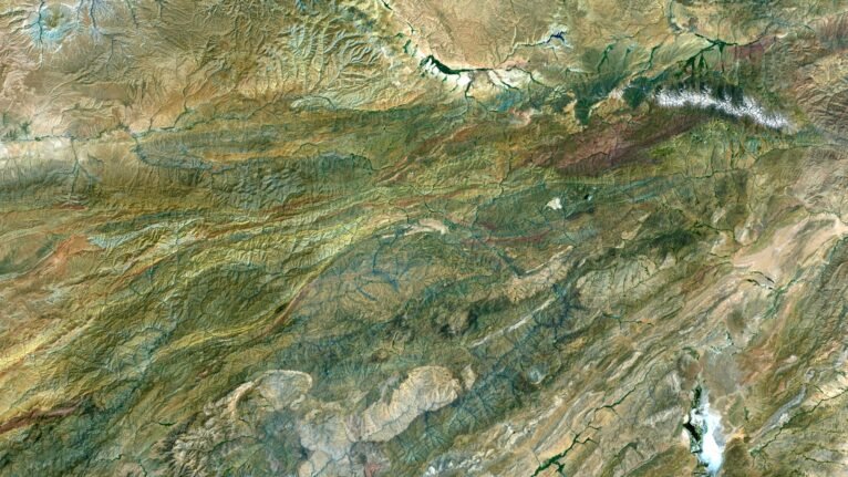 Decorative piece featuring a satellite map of Afghanistan’s natural landscapes.