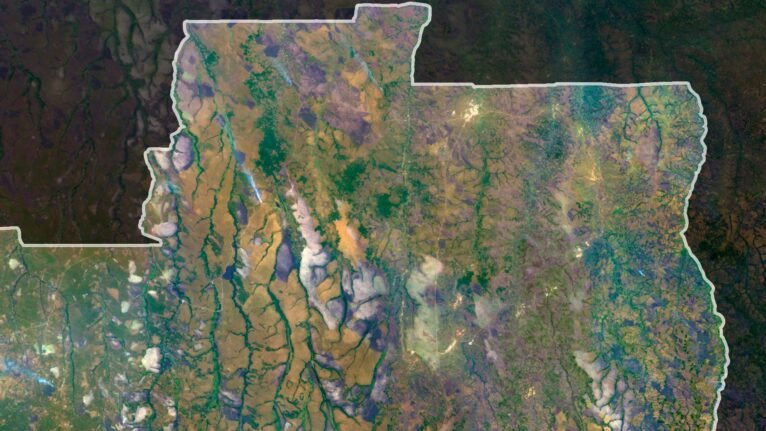 Satellite view of Angola highlighting coastal regions and inland plateaus.