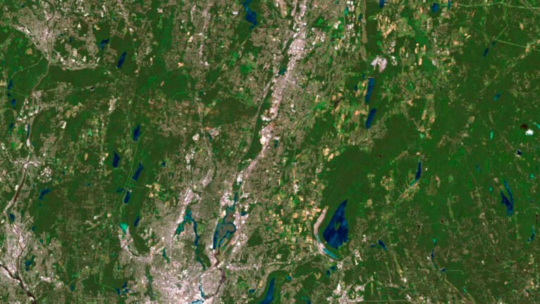 Decorative piece featuring a satellite view of Connecticut’s natural landscapes.