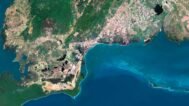 Satellite view of Cuba highlighting coastal areas and inland regions.