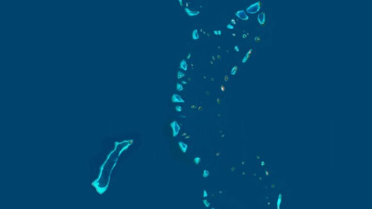 Satellite view of the Maldives highlighting turquoise lagoons and sandy beaches.