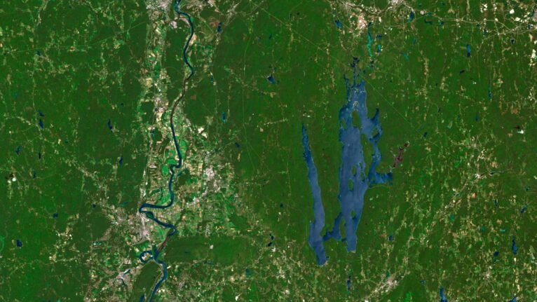 Satellite view of Massachusetts highlighting coastal areas and inland forests.