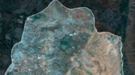 Satellite view of Palestine highlighting urban areas and natural terrains.