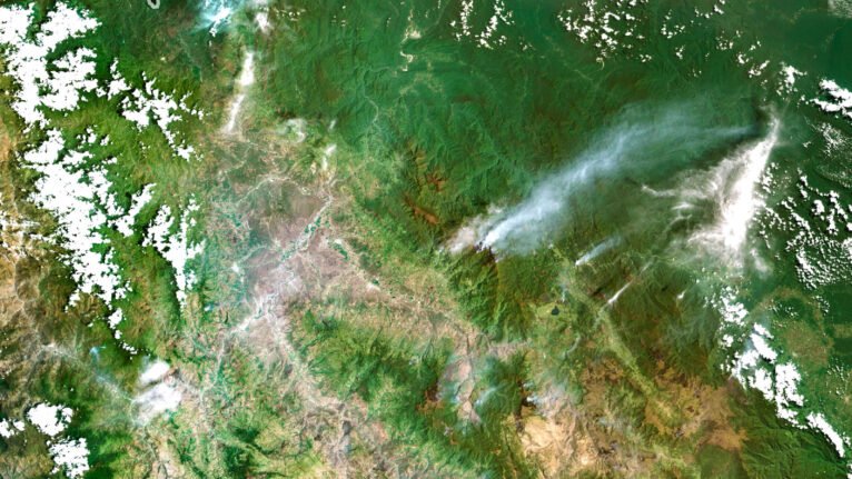 Satellite view of Peru highlighting the Andes Mountains and the Amazon rainforest.