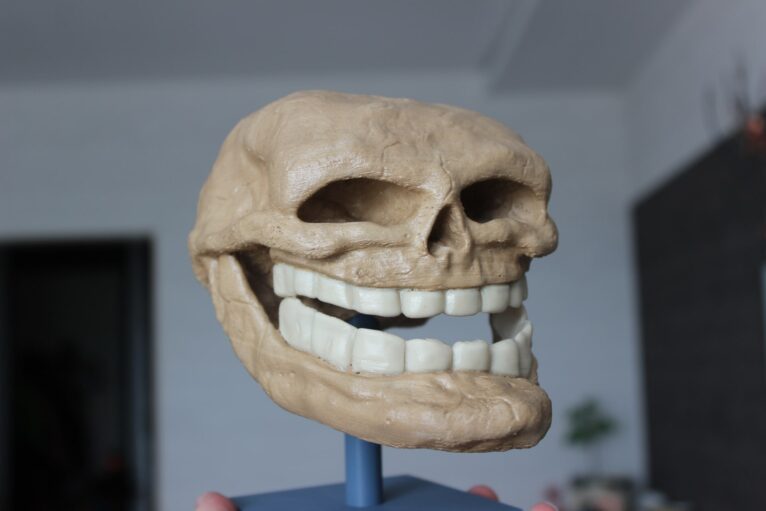 Close-up of 3D-printed Troll Face teeth with exaggerated details for a menacing grin.